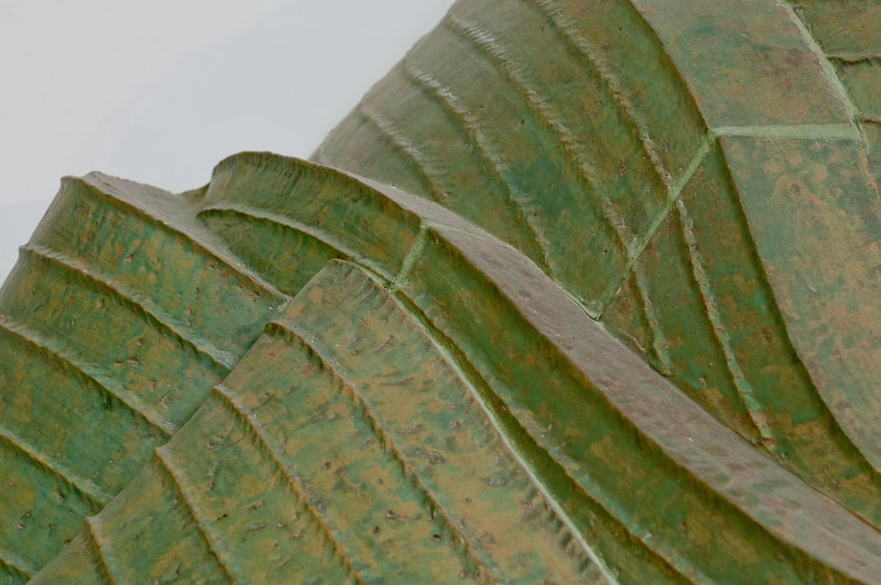 Green glazed tiles with curved edges catching the light.